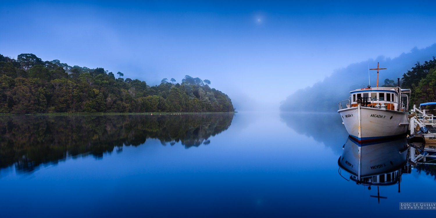 photograph of Dawn light, fog and moon over the Pieman River