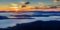 Sunrise on the Derwent River from Mt Wellington with Mt Nelson and Sandy Bay in the foreground.